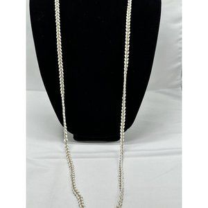 long necklace with gold tone chain and puka shells lined on both sides